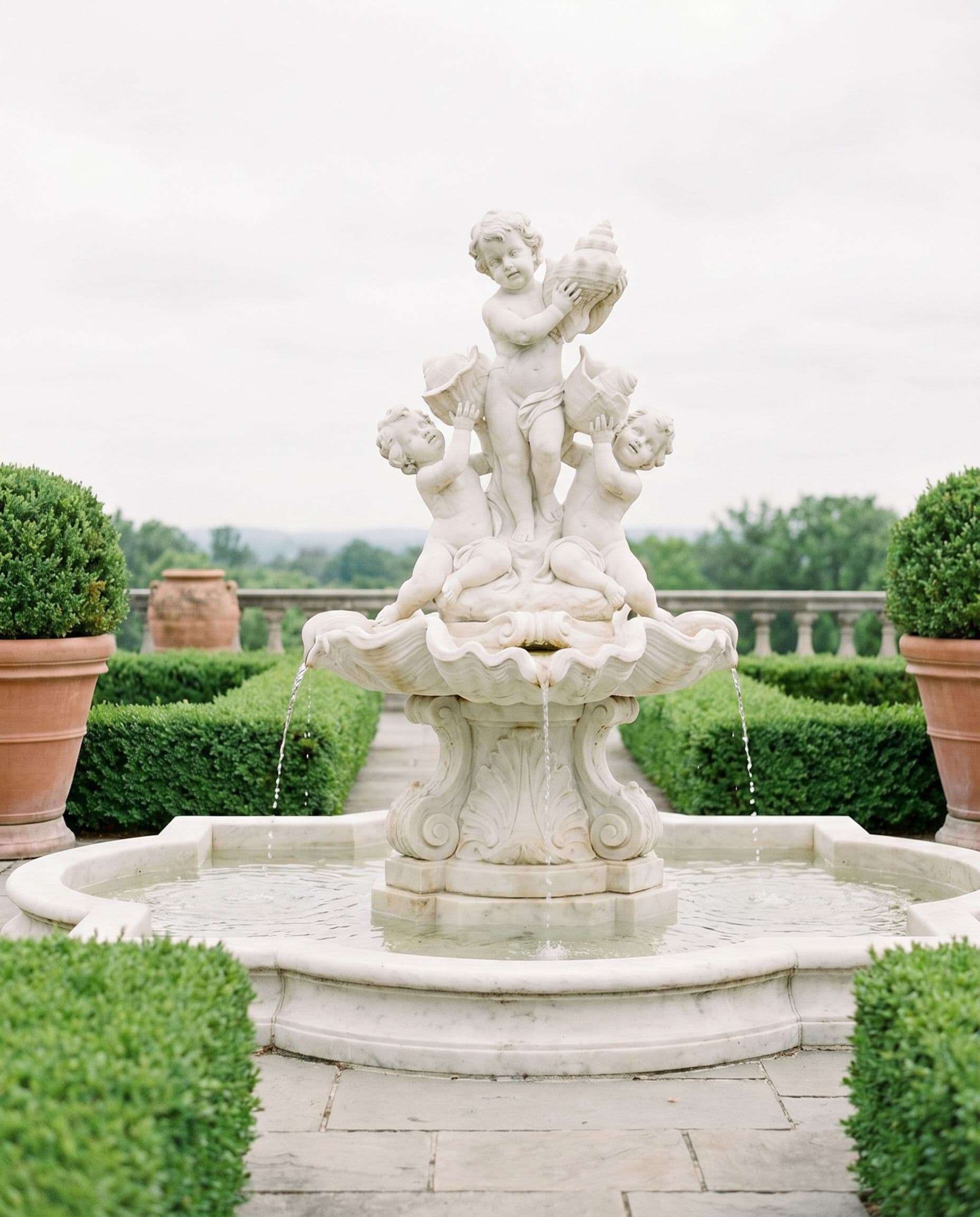 White marble cherub fountain on a formal terrace
