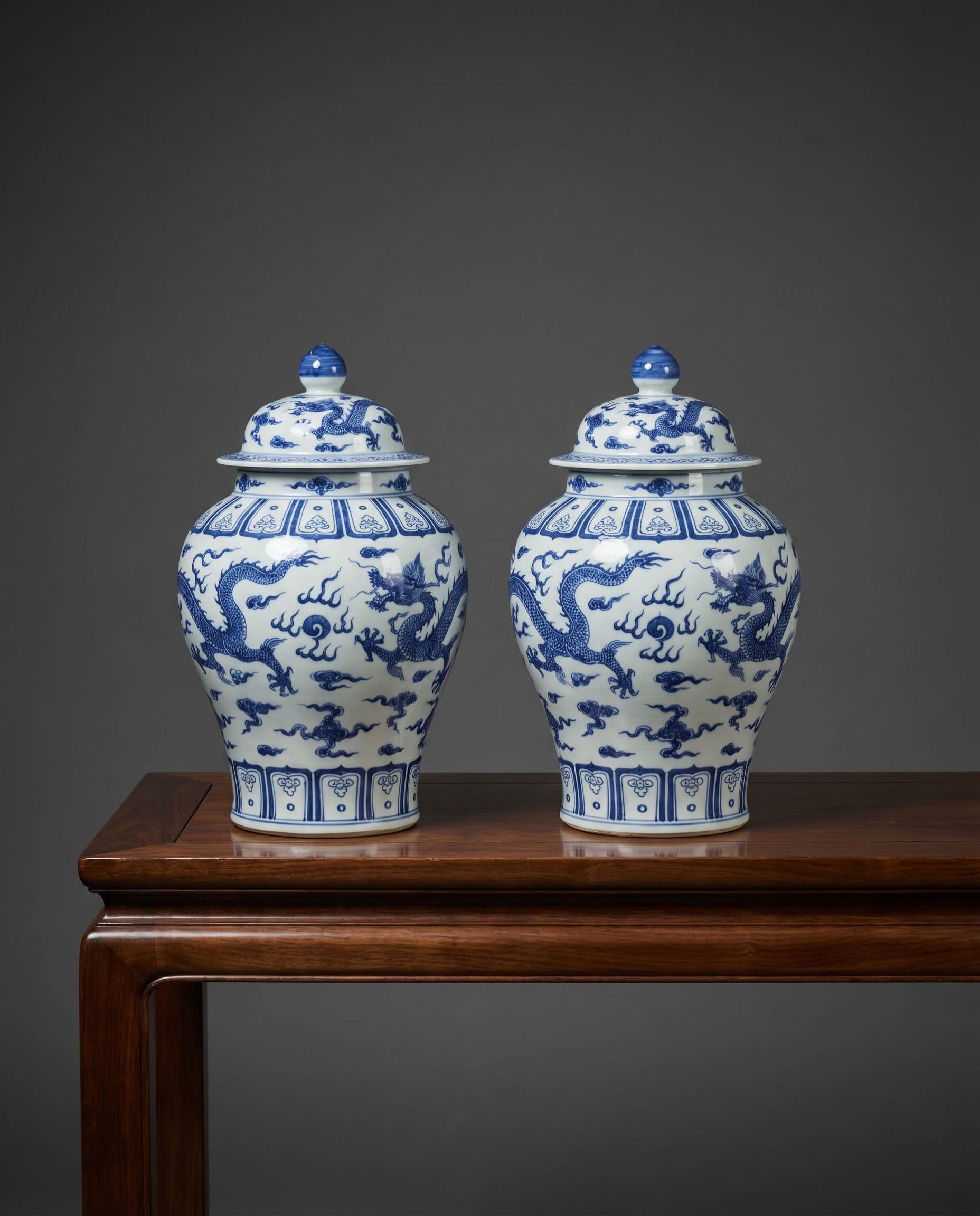 Pair of blue and white porcelain urns with dragon motifs